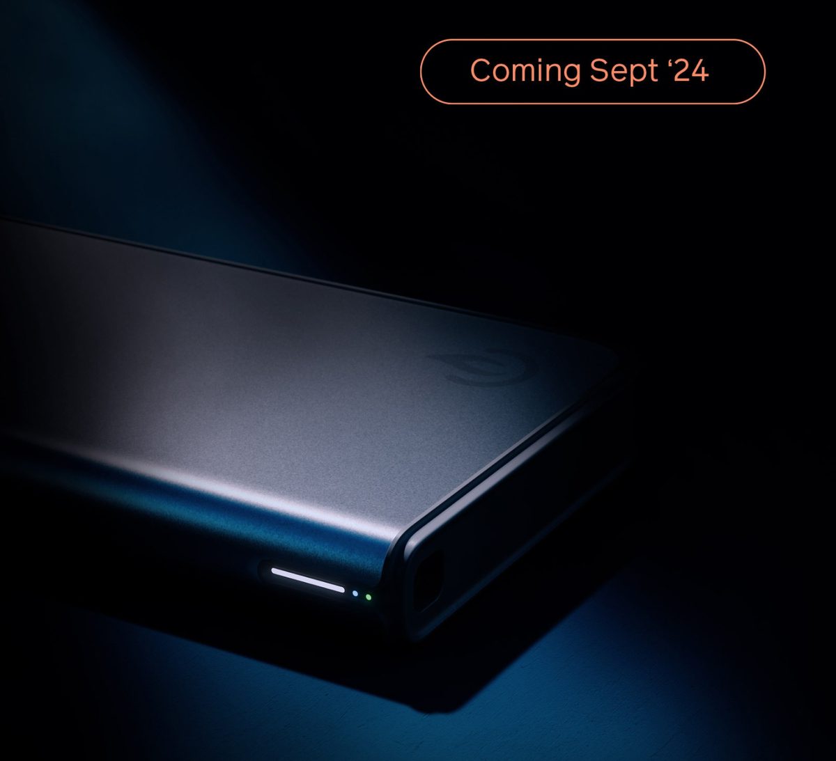 Image of a rectangular hardware in dark environment with text: Coming Sept 24